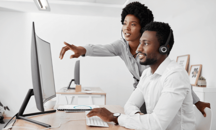 Commercial présentant une solution logicielle à un client dans un bureau moderne.